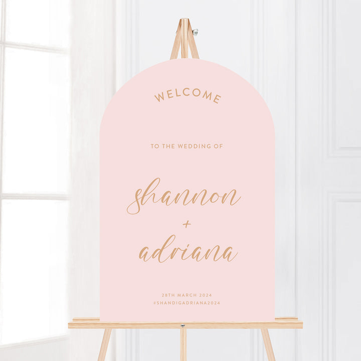 Arch wedding welcome sign in soft blush pink and cinnamon. Calligraphy text and hashtag. Peach Perfect Australia.