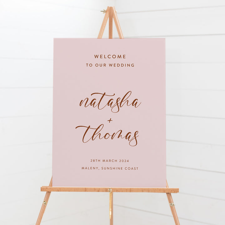 Modern wedding or event welcome sign in soft pink and brownish red or terracotta. Calligraphy text. Peach Perfect Australia.