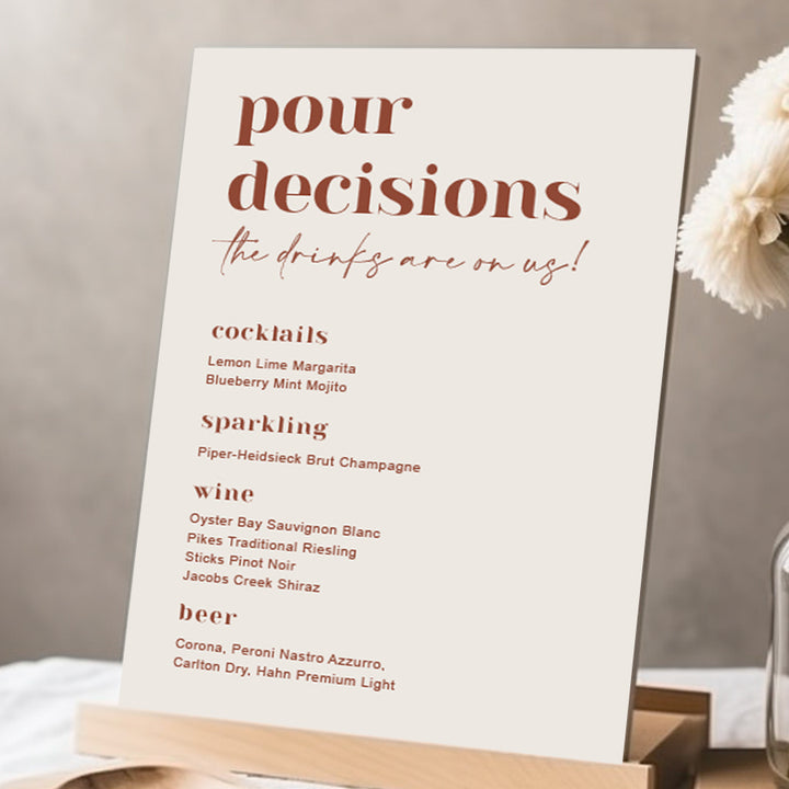 Modern wedding bar sign with heading Pour Decisions and the drinks are on us. Printed in Australia in neutral colours on Foamboard or Acrylic.