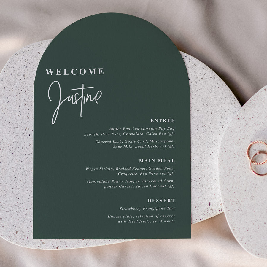 Arch wedding menu, modern font styles with guest name printing on dark green forest card. Printed in Australia by Peach Perfect Stationery.
