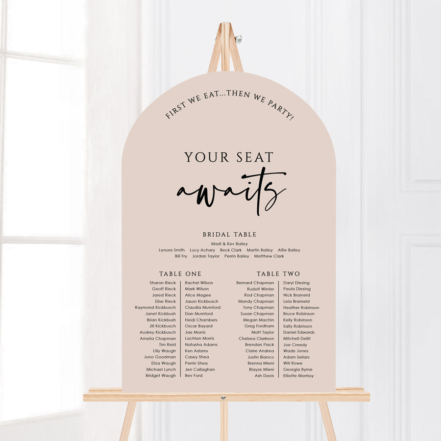 Modern wedding arch shape seating chart with nude pink colour background and black writing. Banquet table layout designed and printed in Australia by Peach Perfect.