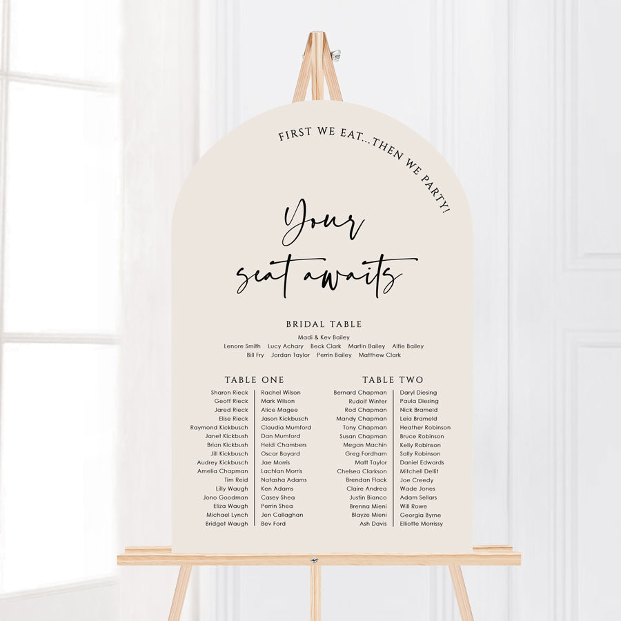 Modern wedding arch shape seating chart with almond colour background and black writing. Banquet table layout designed and printed in Australia by Peach Perfect.