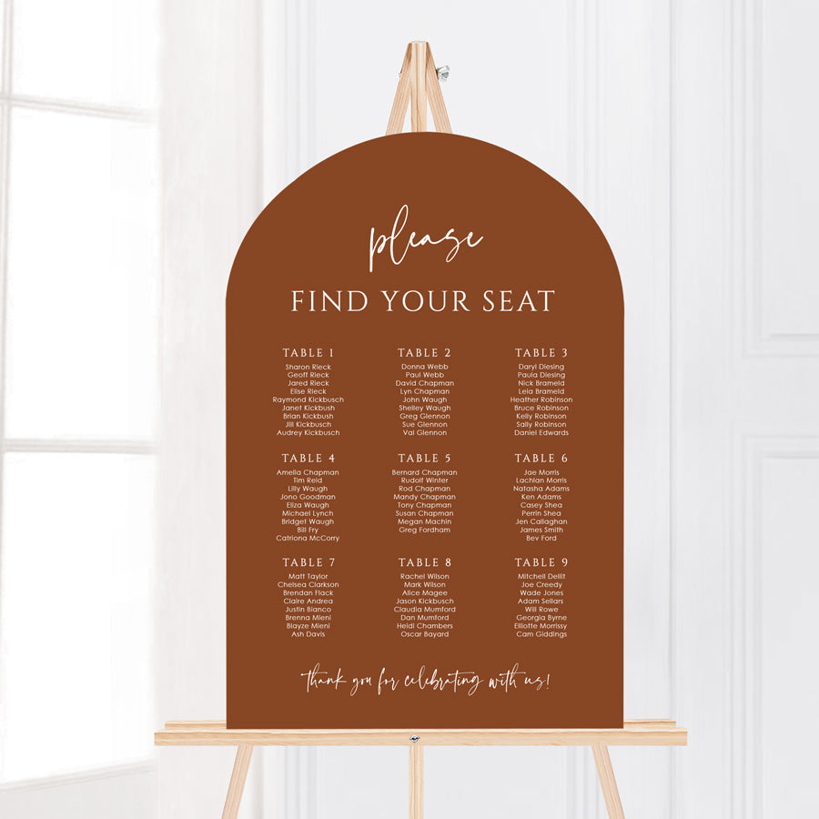 Modern wedding arch shape seating chart with reddish brown colour background and white writing. Banquet table layout designed and printed in Australia by Peach Perfect.