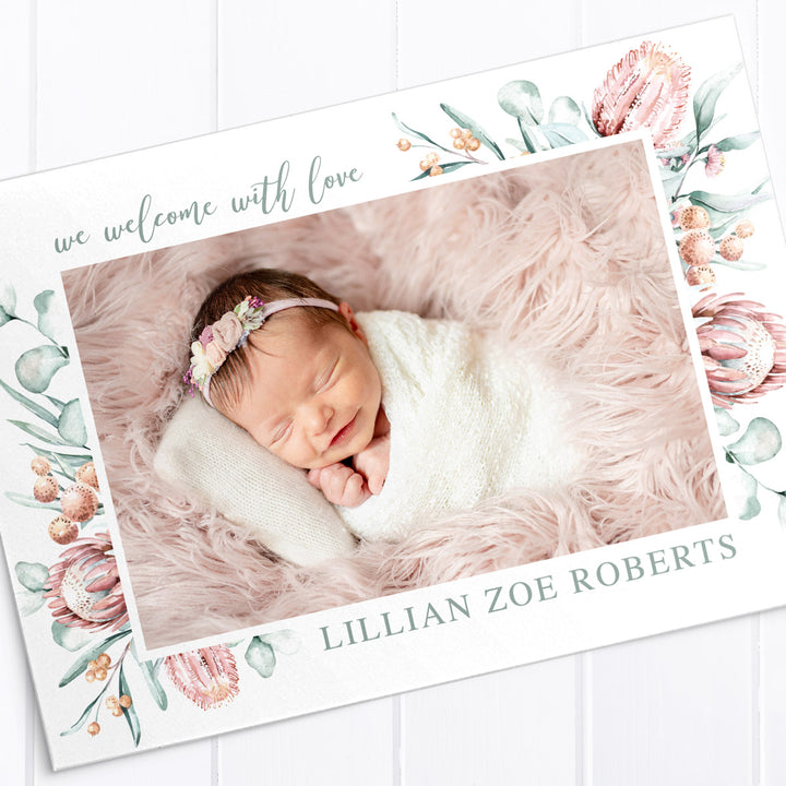 Baby girl birth announcement card with photo of baby and australian native flowers and greenery border, double sided