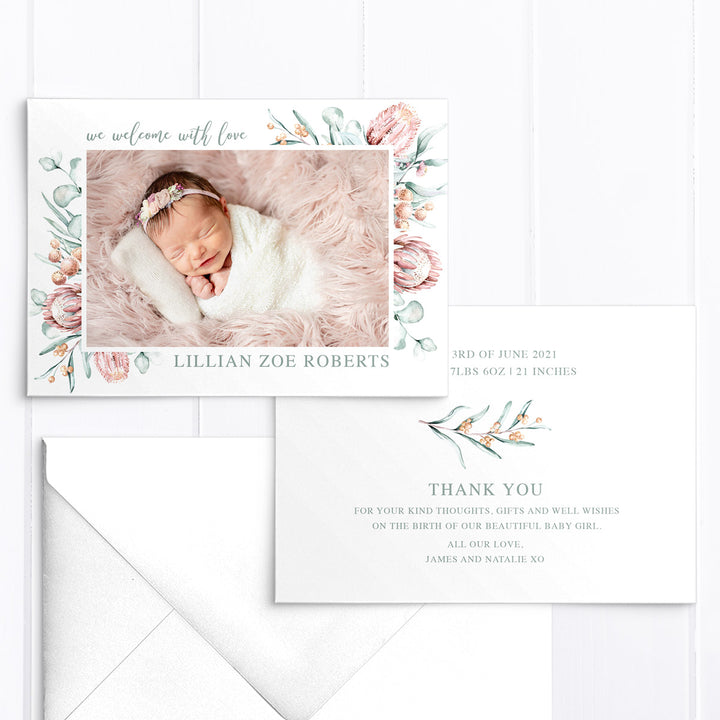 Baby girl birth announcement card with photo of baby and australian native flowers and greenery border, designed and printed in Australia