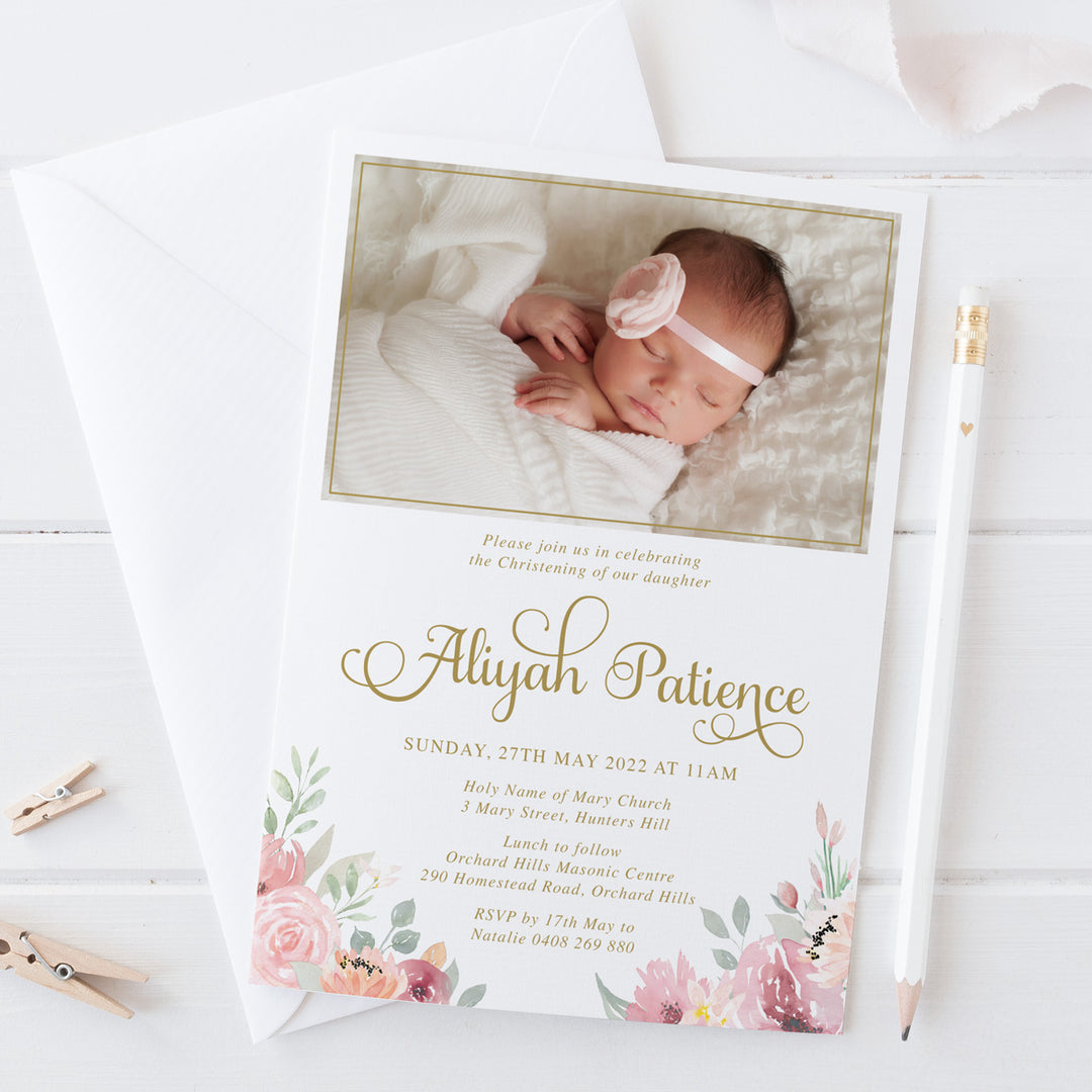 Baby girl photo baptism invitation with soft pink and apricot florals and greenery, and gold text. Designed and printed in Australia or print your own printable file.