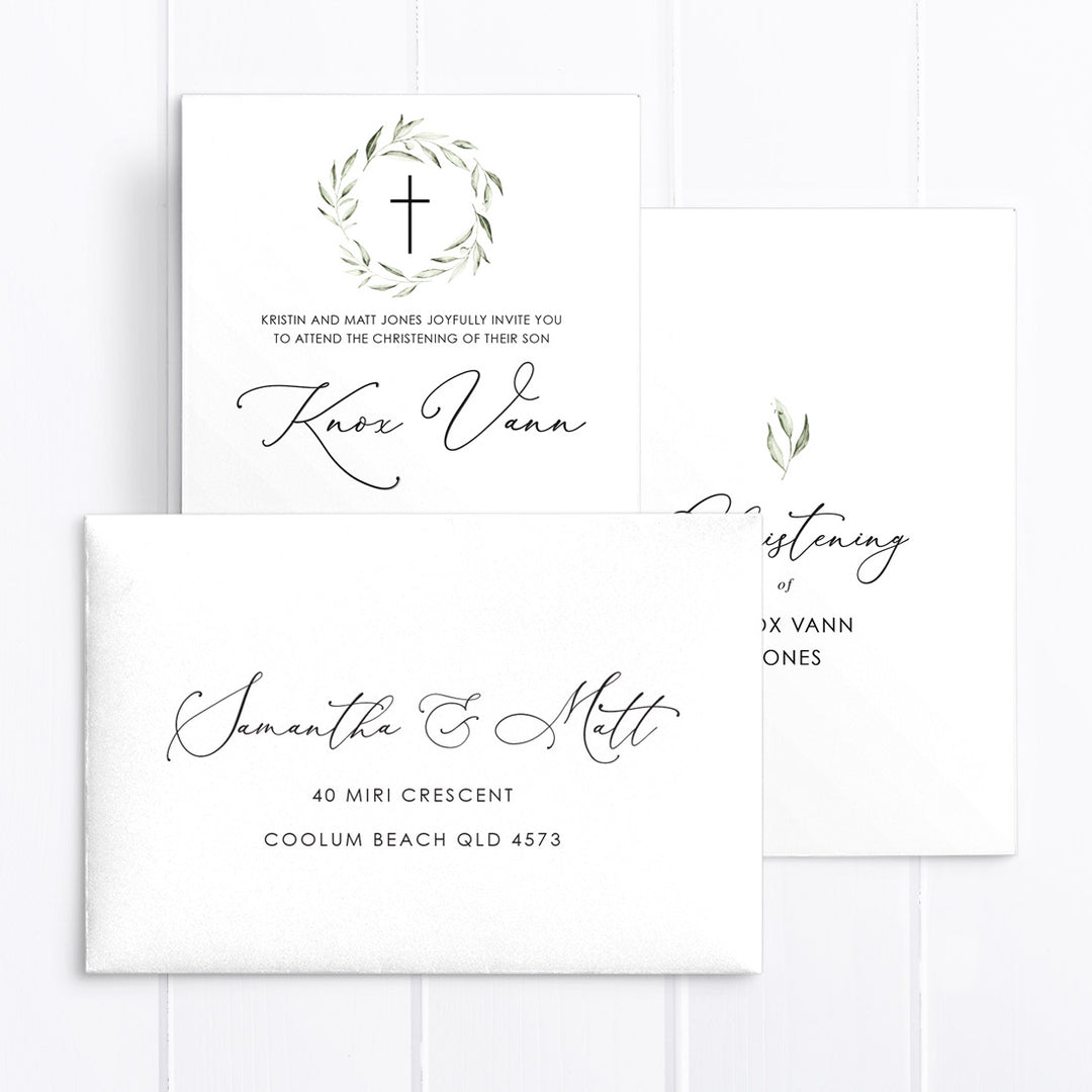 Minimal boy baptism or Christening invitation with greenery wreath and calligraphy font, and matching printed envelopes.
