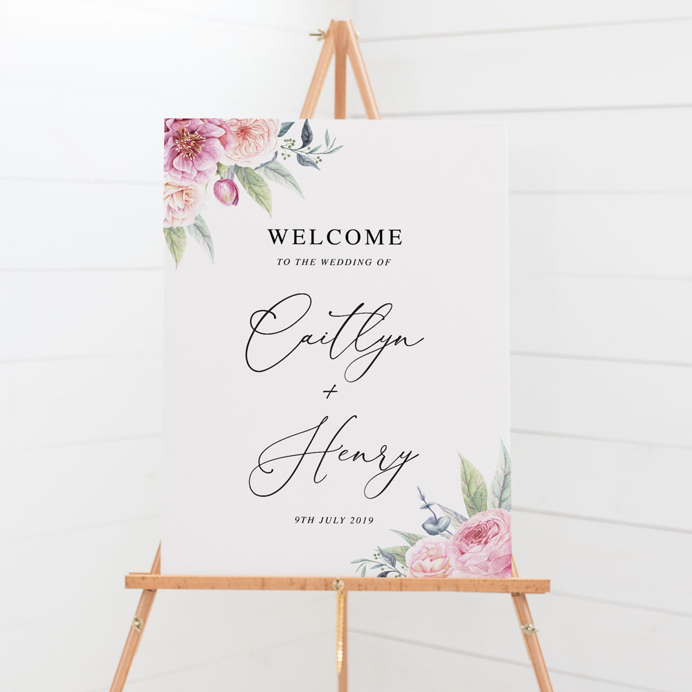 Wedding welcome sign board with calligraphy font and beautiful soft pink florals and greenery in two corners, printed in Australia .
