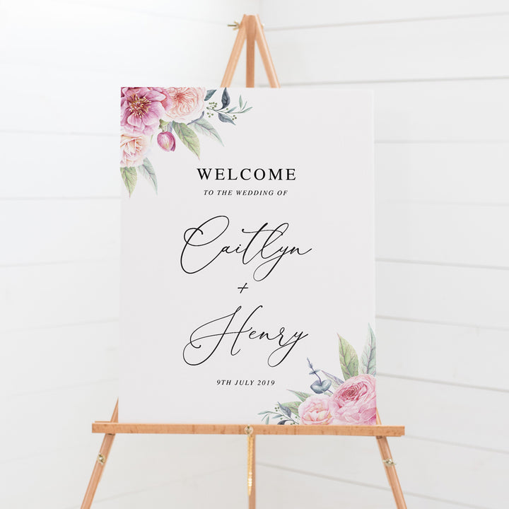 Wedding welcome sign board with calligraphy font and beautiful soft pink florals and greenery in two corners, printed in Australia .