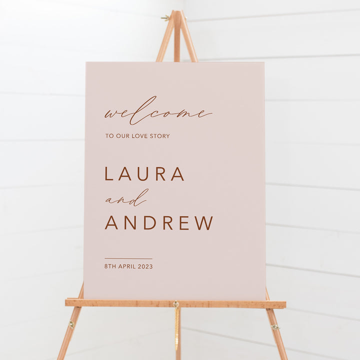 Modern boho wedding welcome sign with blush pink background and terracotta text. Printed in Australia on smooth board for sitting on an easel.