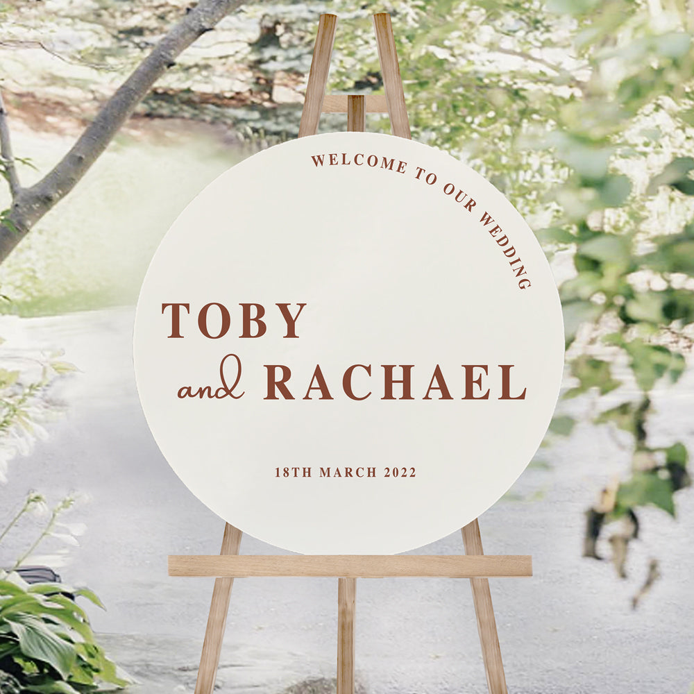 Modern bold wedding welcome sign in round shape, printed on ivory foamboard with terracotta text. Welcome to our wedding heading.
