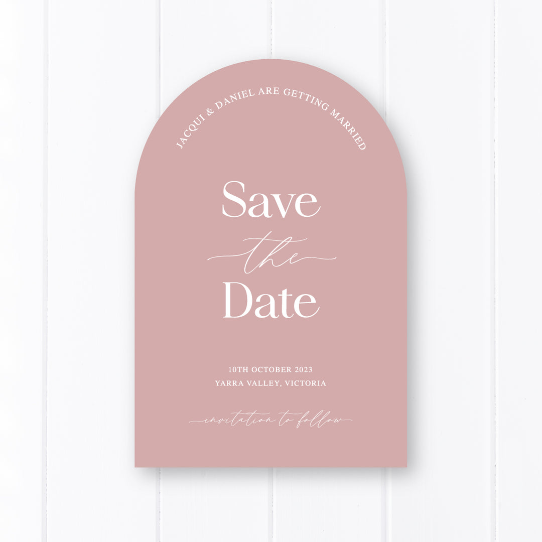 Modern wedding save the date card in arch shape. white text ink on dusty pink cardstock. Peach Perfect Australia.