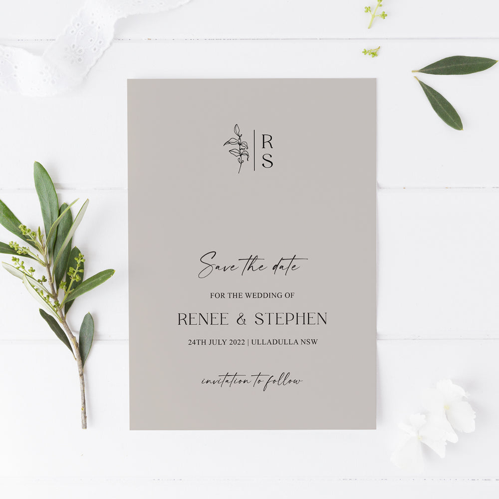 Minimal wedding save the date card with monogram at the top and hand drawn leaf, calligraphy on stone cardstock. Peach Perfect Australia