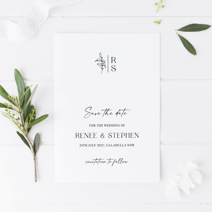 Minimal wedding save the date card with monogram at the top and hand drawn leaf, calligraphy on white cardstock. Peach Perfect Australia