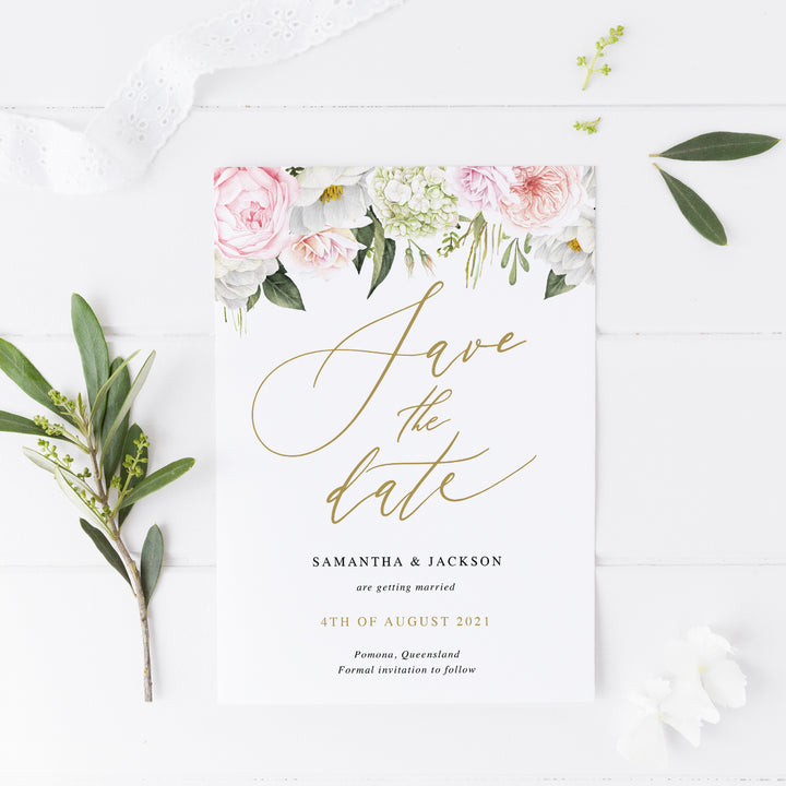 Wedding save the date card with pink and coral flowers and greenery at top. Calligraphy font in gold. Designed and printed in Australia or Digital Print Your Own.