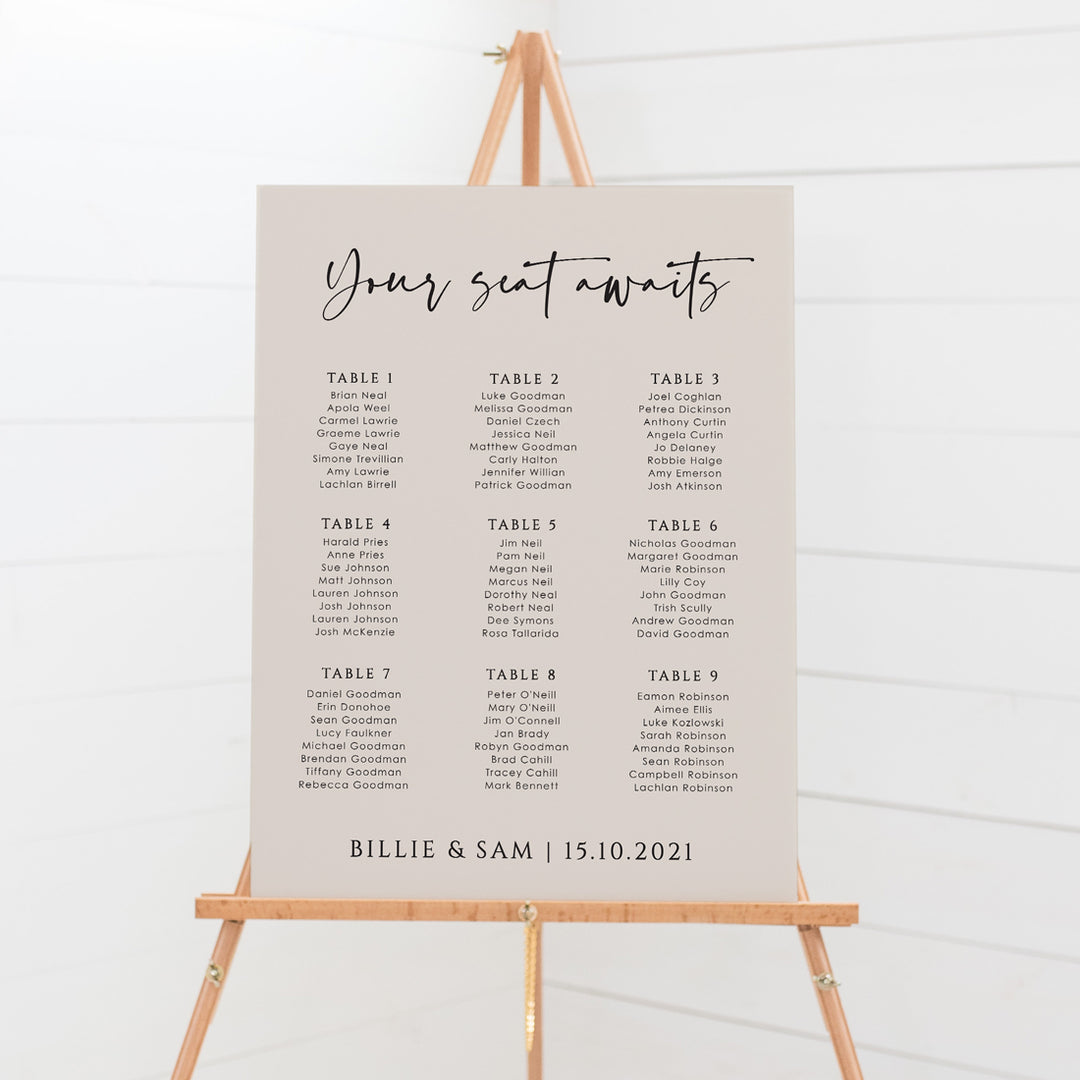 Modern wedding seating chart on Almond background pink with black writing. Your seat awaits. Nine tables. Designed and printed in Australia by Peach Perfect.