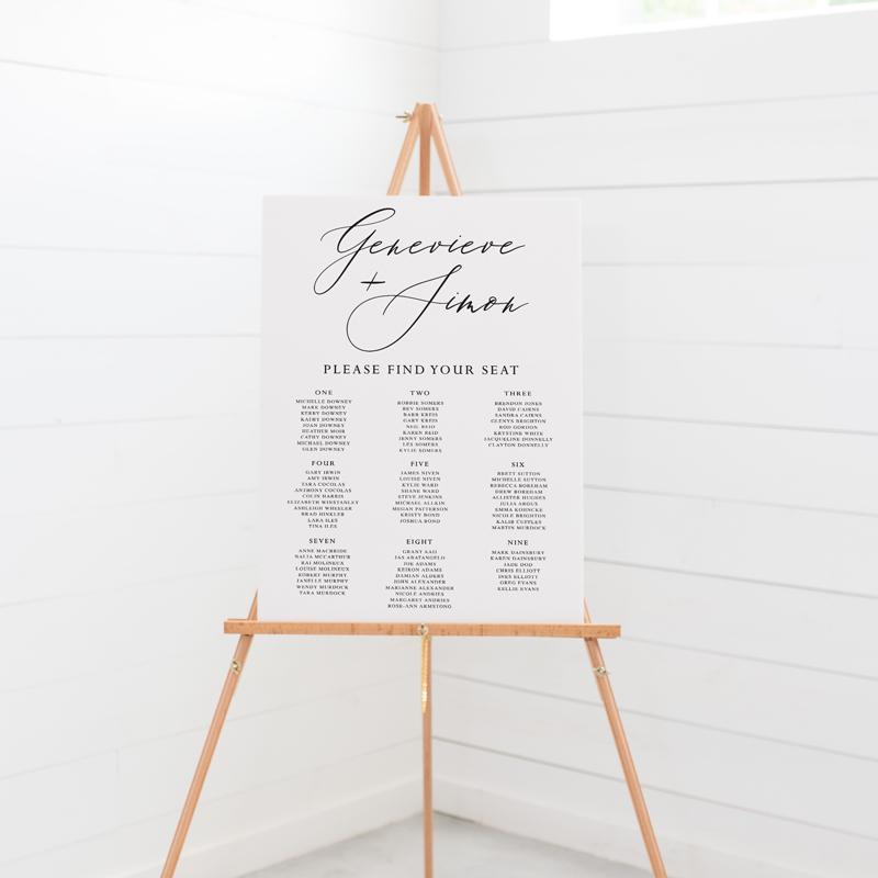 Wedding seating chart on board, black and white, large heading in script font