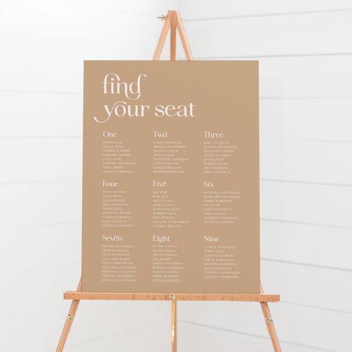 Modern wedding seating chart with calligraphy and bold fonts in cinnamon colour and white. Fin your seat heading. Peach Perfect Australia.