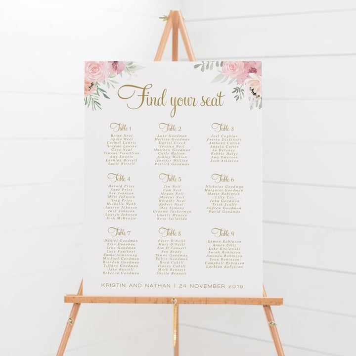 Wedding seating chart with gold text and soft pink flowers and leaves