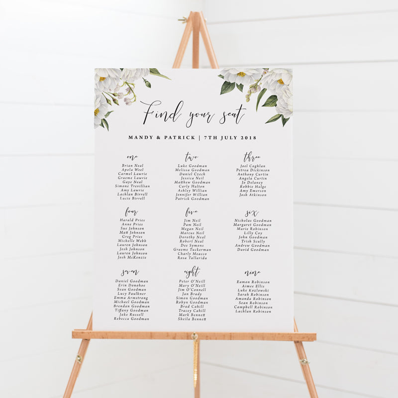 Wedding seating chart professionally designed with white corner florals andn modern script font