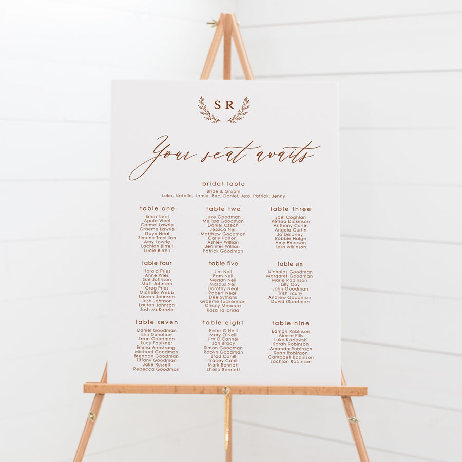 Wedding seating chart with monogram of bride and grooms initials and calligraphy font. Printed on pvc foam board or acrylic.