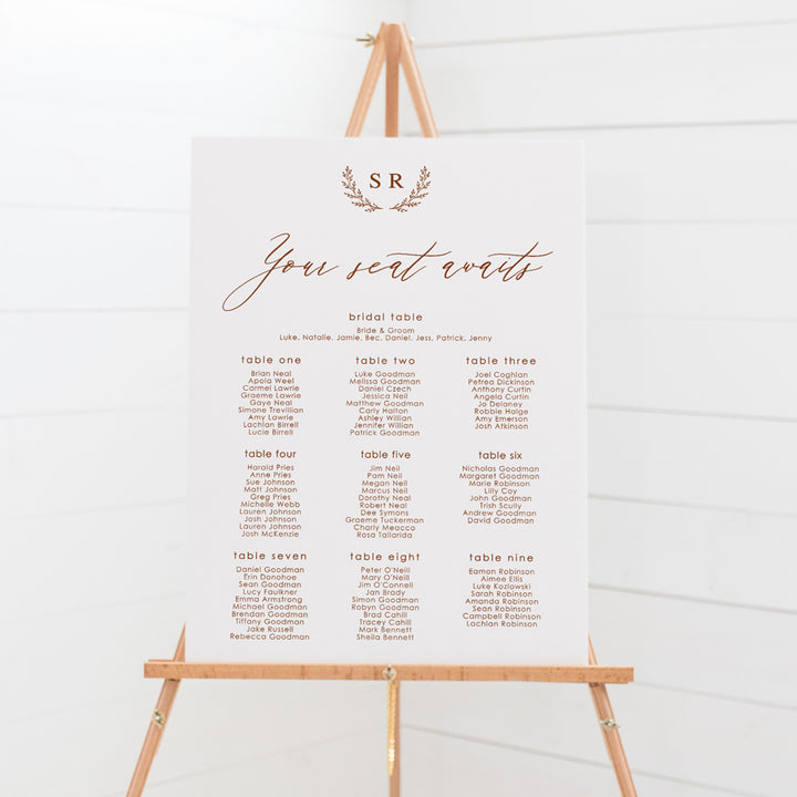 Wedding seating chart with monogram of bride and grooms initials and calligraphy font. Printed on pvc foam board or acrylic.