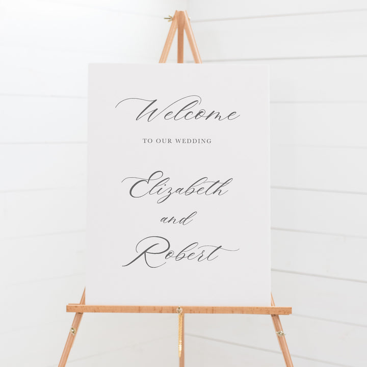 Traditional wedding welcome sign on board with calligraphy for the bride and grooms name.