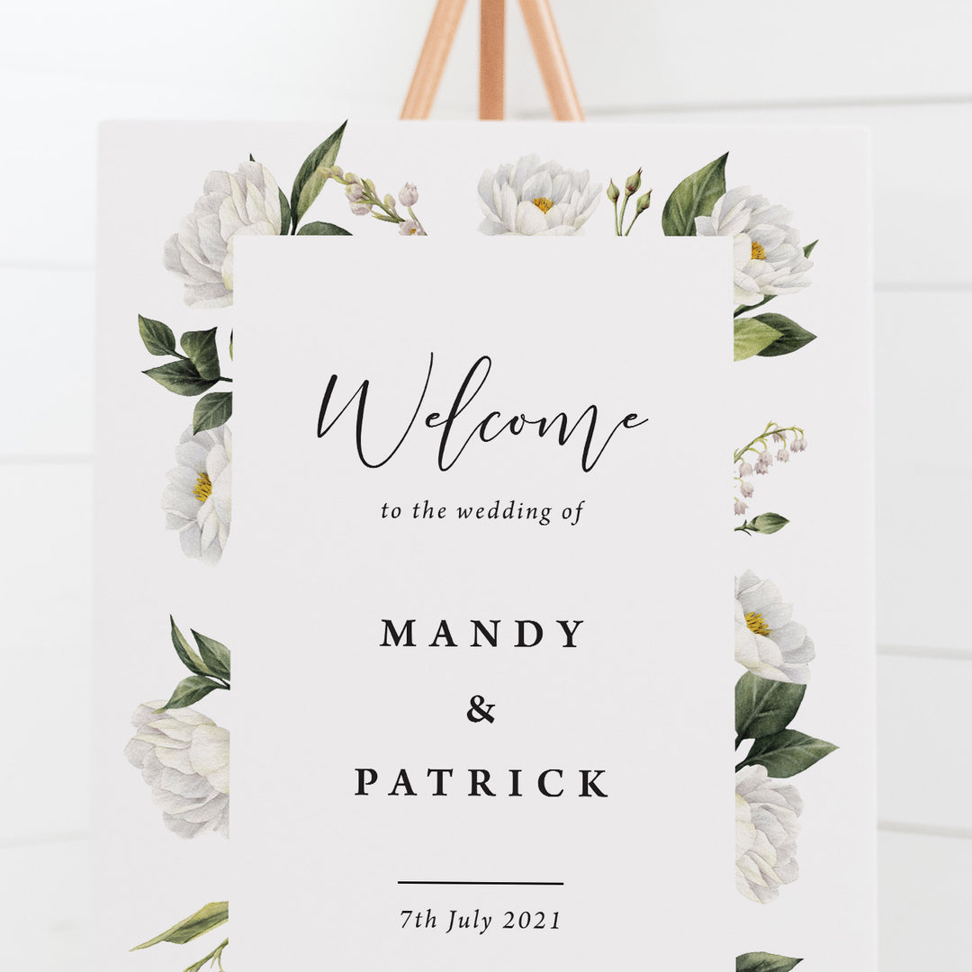Wedding welcome sign board with white floral and greenery border