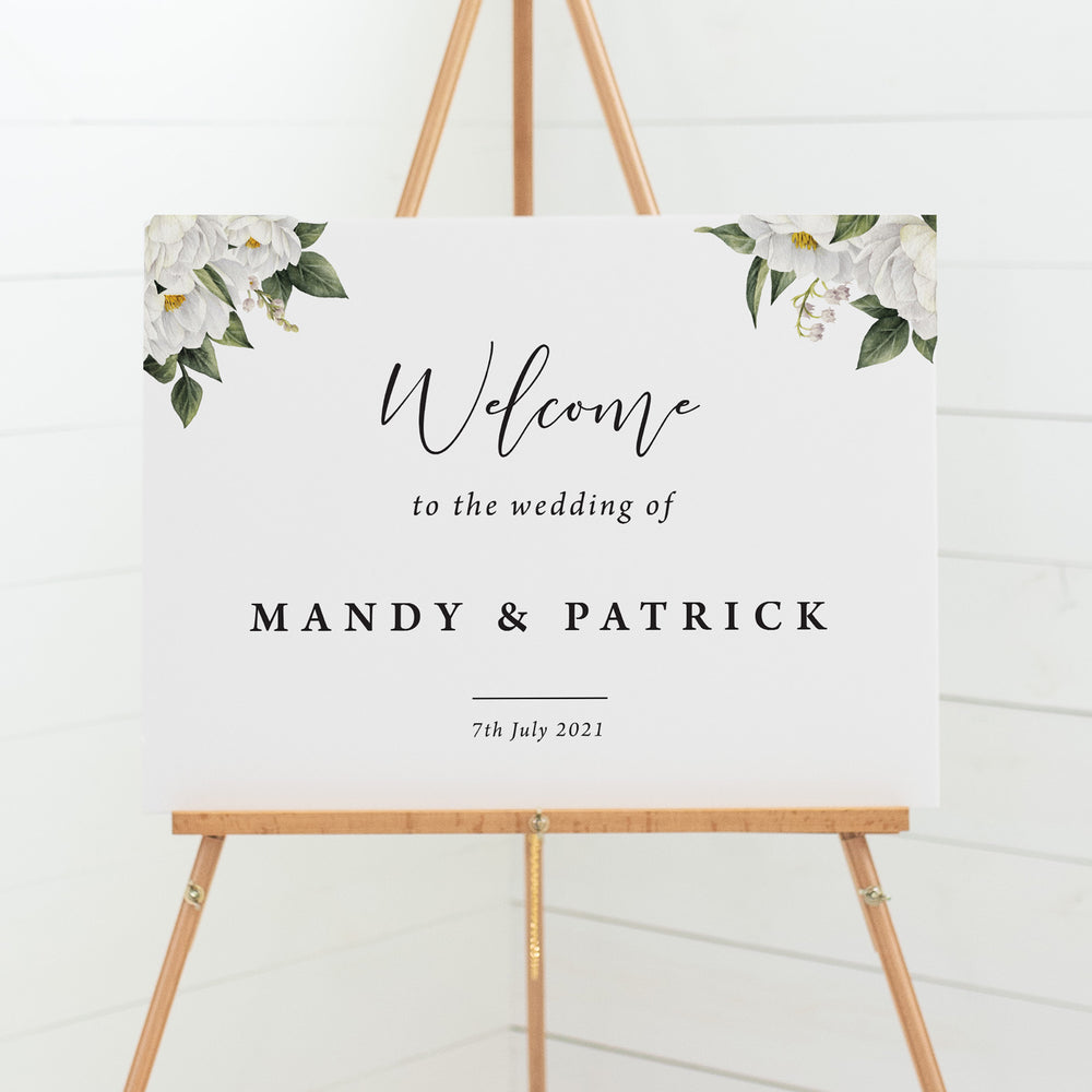 Wedding welcome sign board with white floral and greenery border