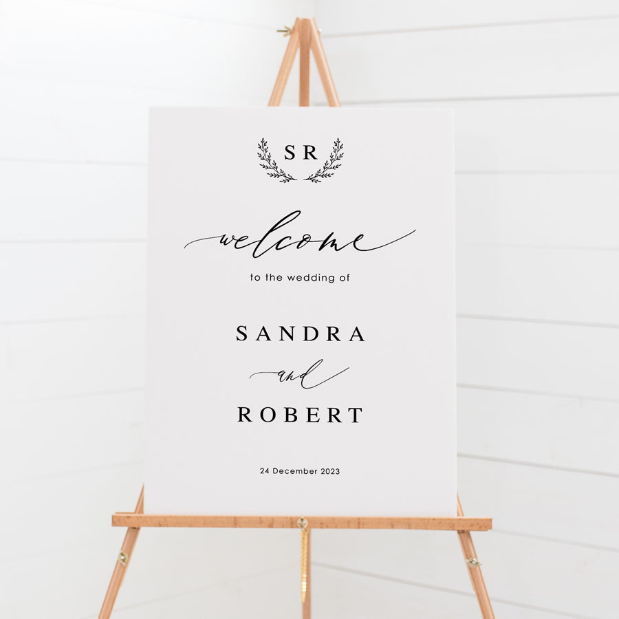 Wedding welcome sign board with calligraphy font and monogram of bride and grooms initials in black and white. Peach Perfect.