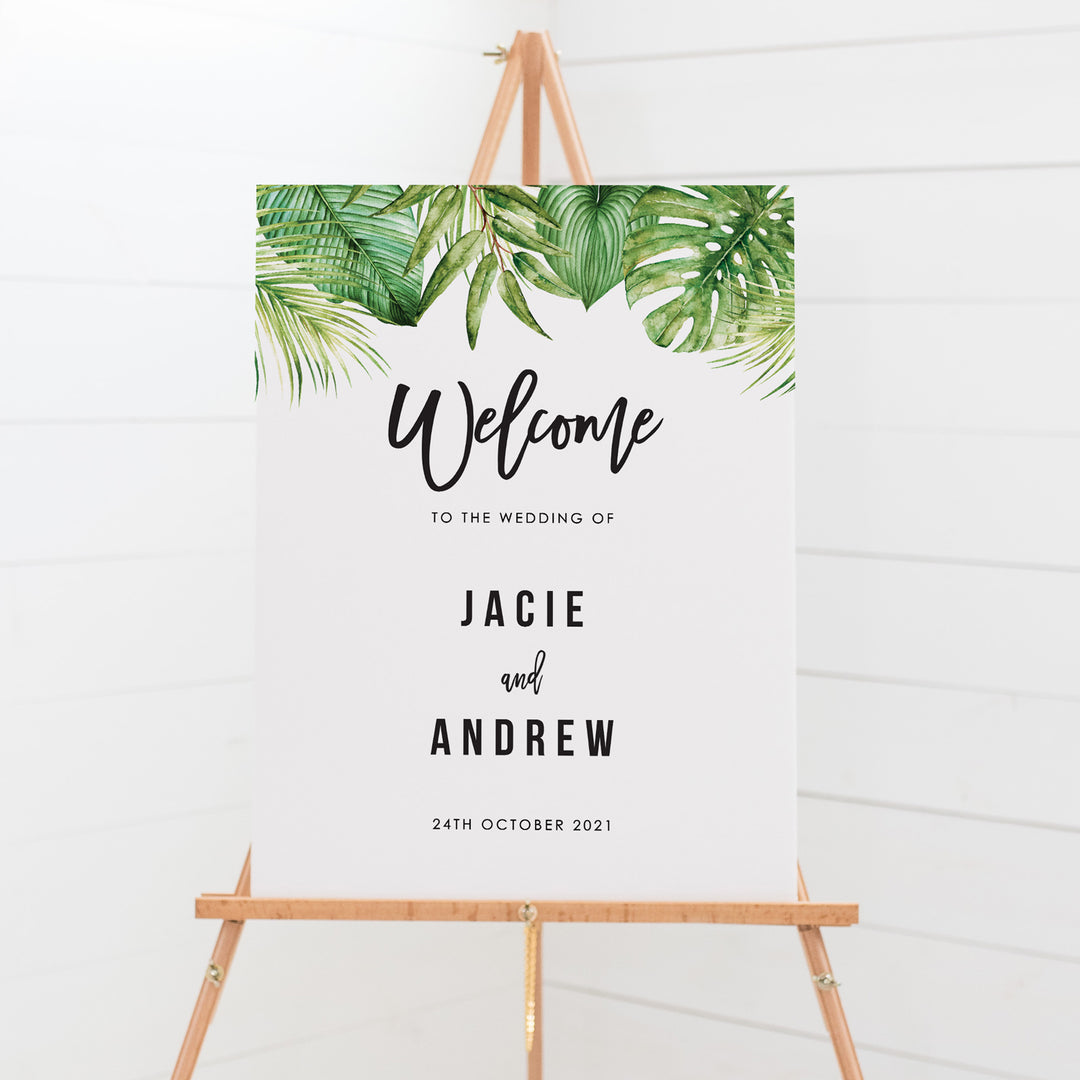 Wedding welcome sign board with large tropical leaves at the top and modern font styles
