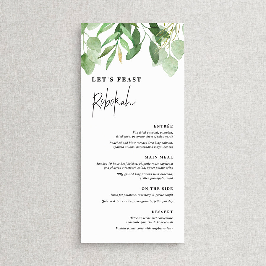 Wedding menu with greenery and eucalyptus leaves and modern font style with guest name printing.