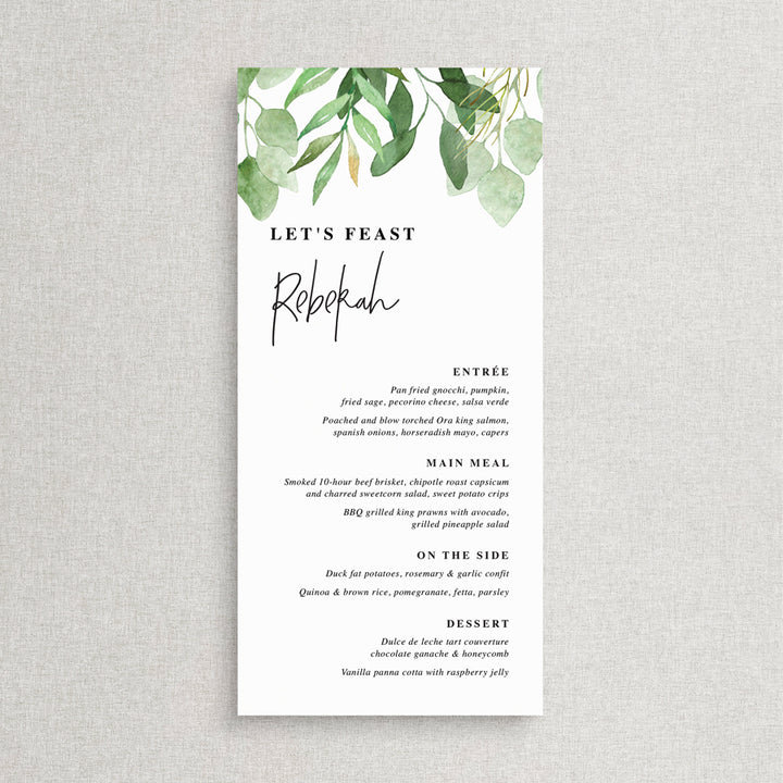 Wedding menu with greenery and eucalyptus leaves and modern font style with guest name printing.
