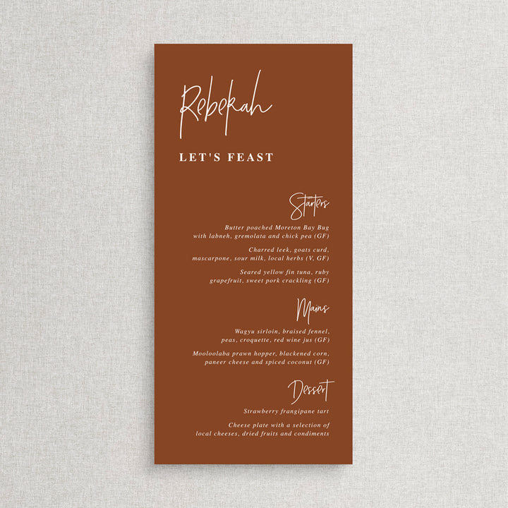 Modern wedding menu on rust or harvest cardstock with white ink. Guest names on each menu and lets feast for heading.