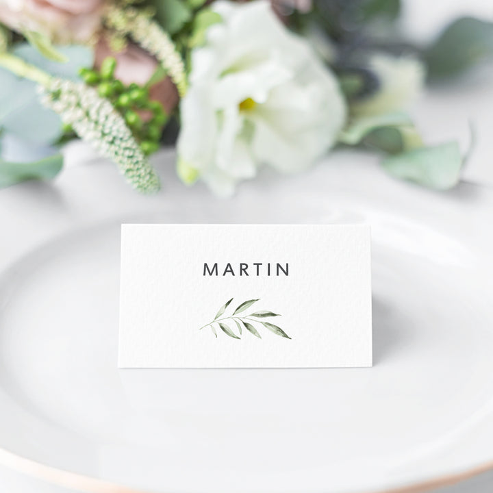 Wedding folded place card with watercolour leaf and charcoal grey text for guest names. Peach Perfect Stationery Australia